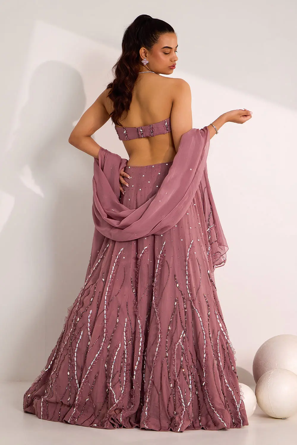 Back view of mauve organza lehenga choli with embroidered blouse