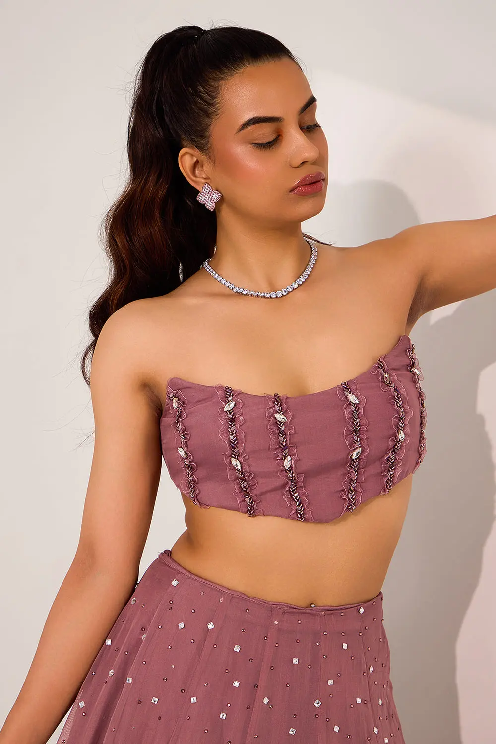 Close up of mix media embroidery on mauve organza lehenga