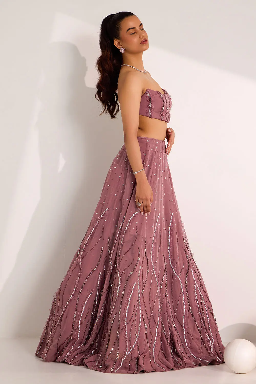 Side view of mauve organza lehenga showing flare and embroidery