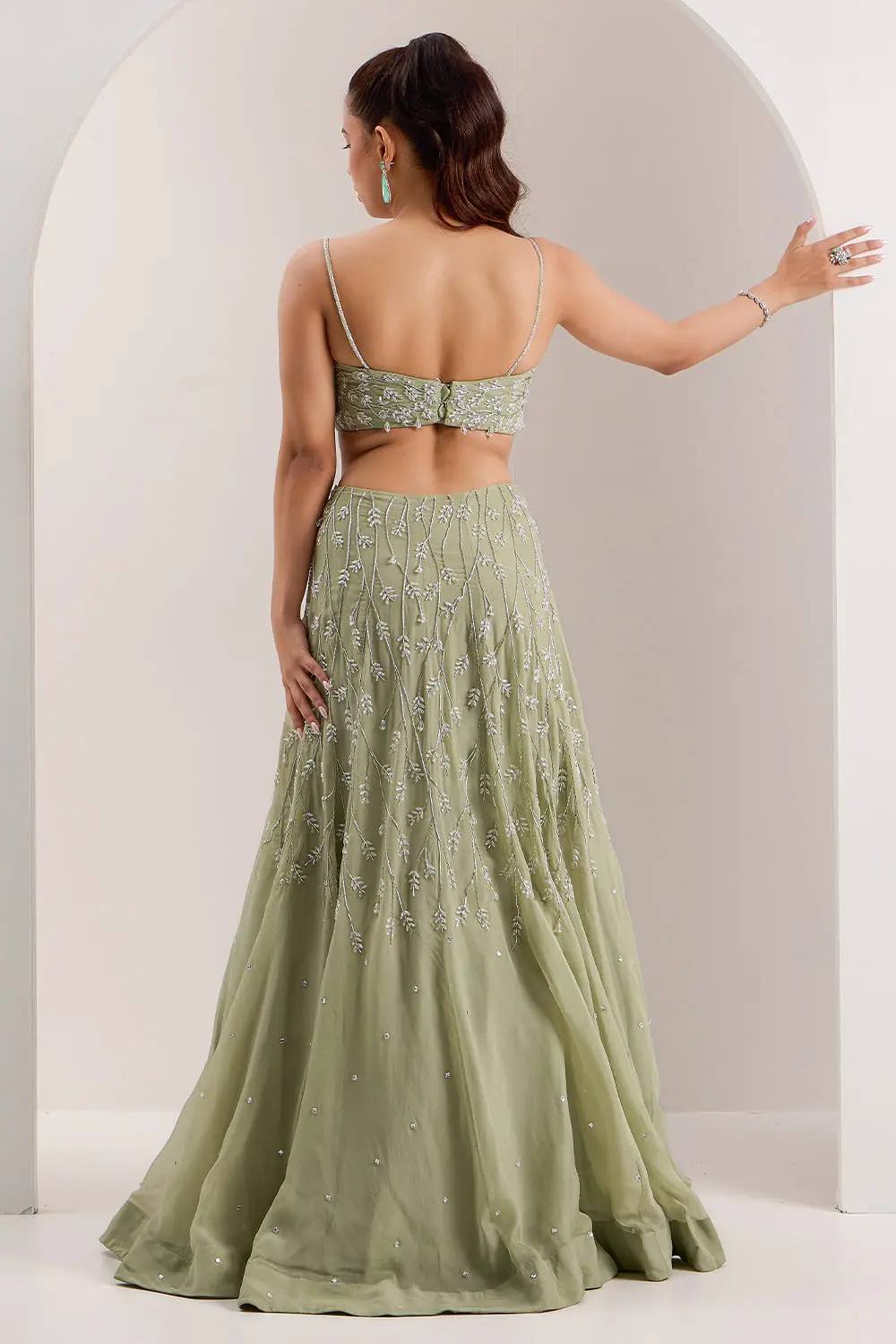 Back view of mint green organza lehenga choli with embroidered blouse