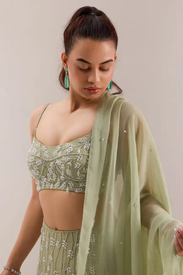 Close up of crystal and cut dana embroidery on mint green lehenga