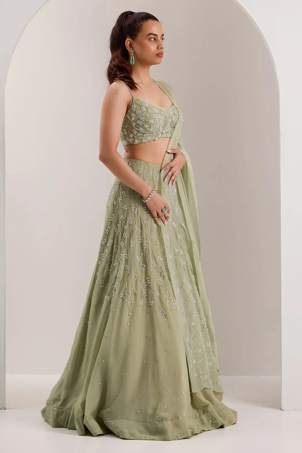 Soft mint green organza lehenga choli with dupatta draped view