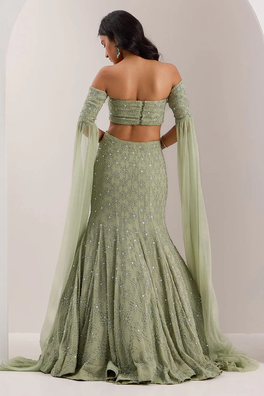 Back view of mint green mermaid lehenga with off shoulder blouse