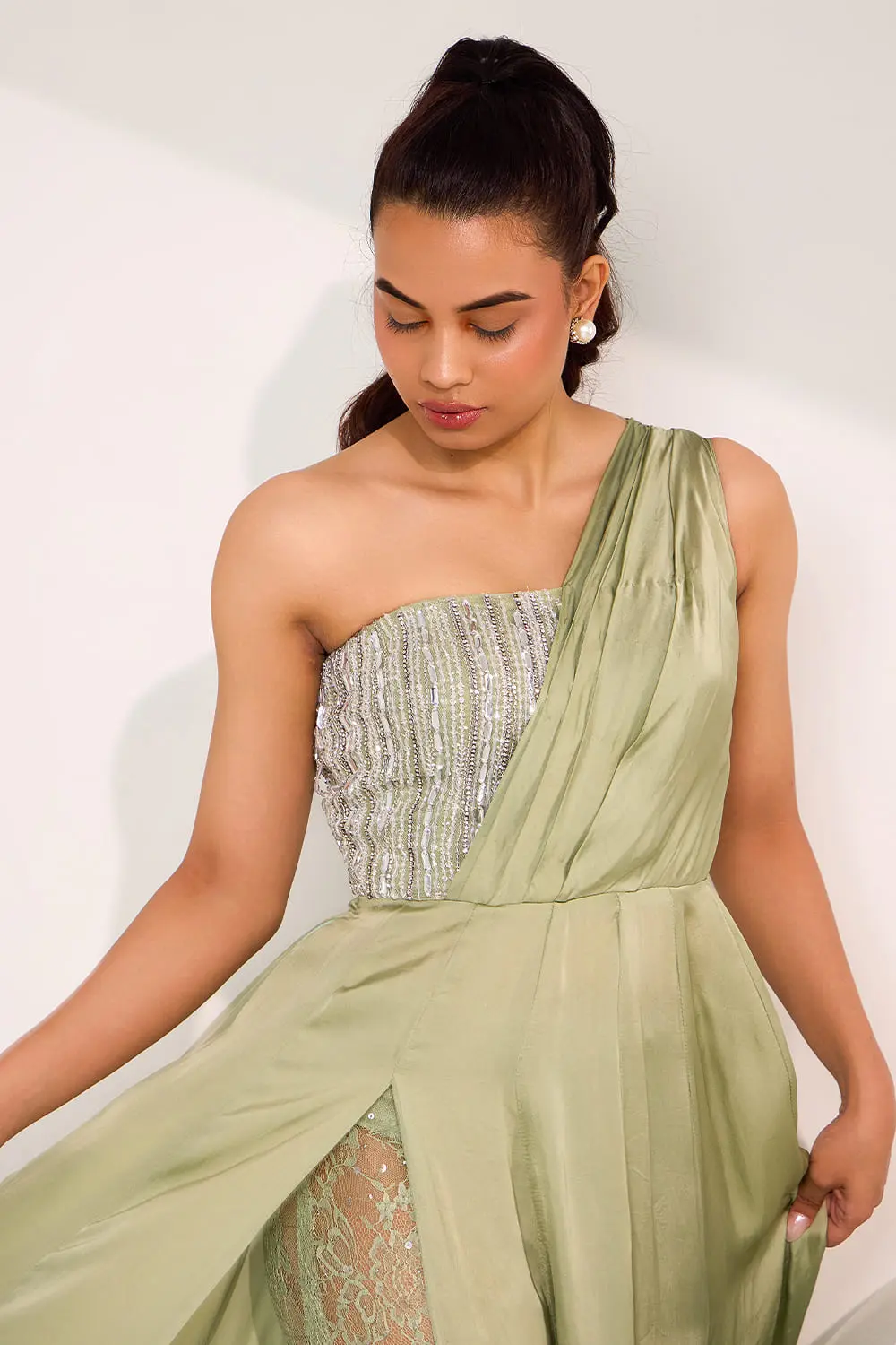 Close up of mix media embroidery on mint green one shoulder gown