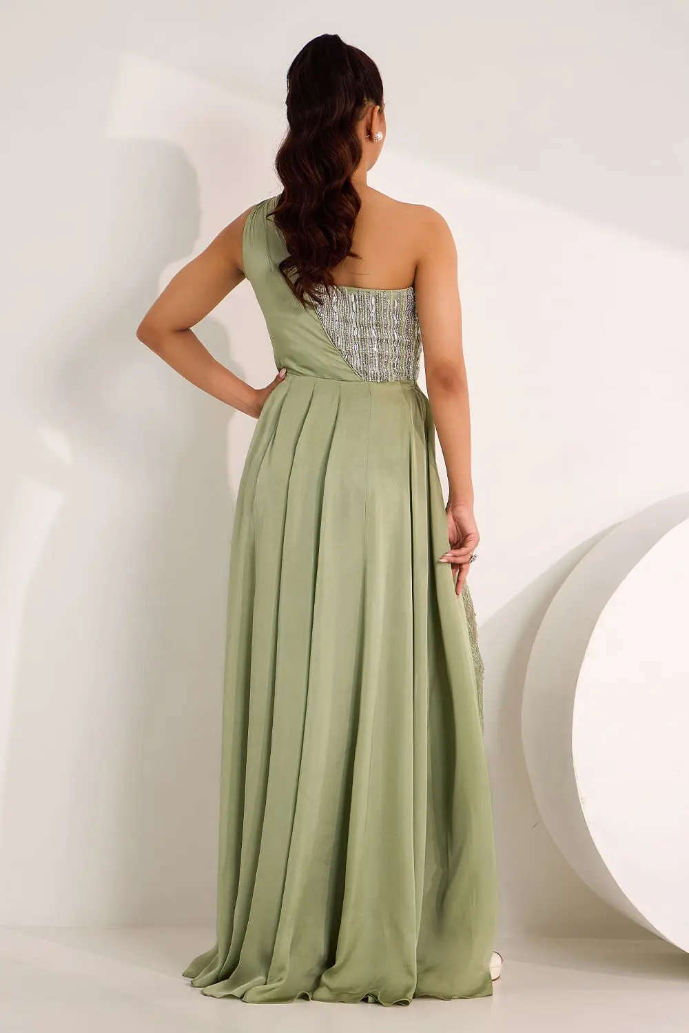 Back view of mint green one shoulder high slit gown