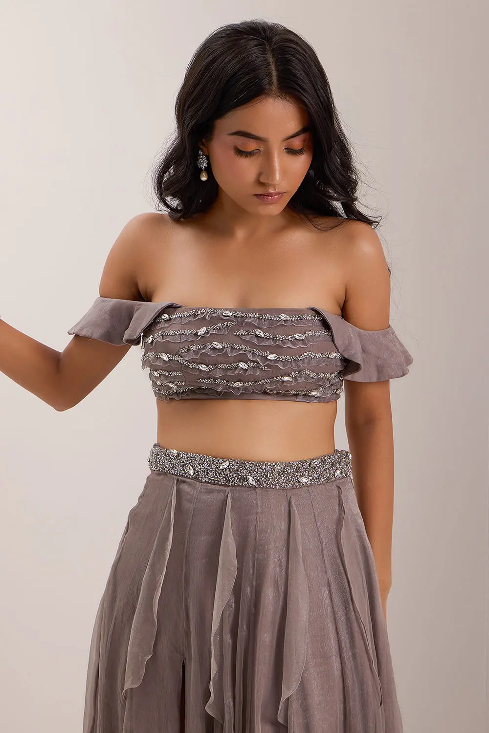 Close up of crystal and mix media embroidery on grey off shoulder blouse