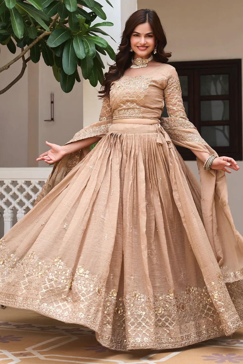 Golden beige crunchy silk lehenga styled with heavy embroidered dupatta