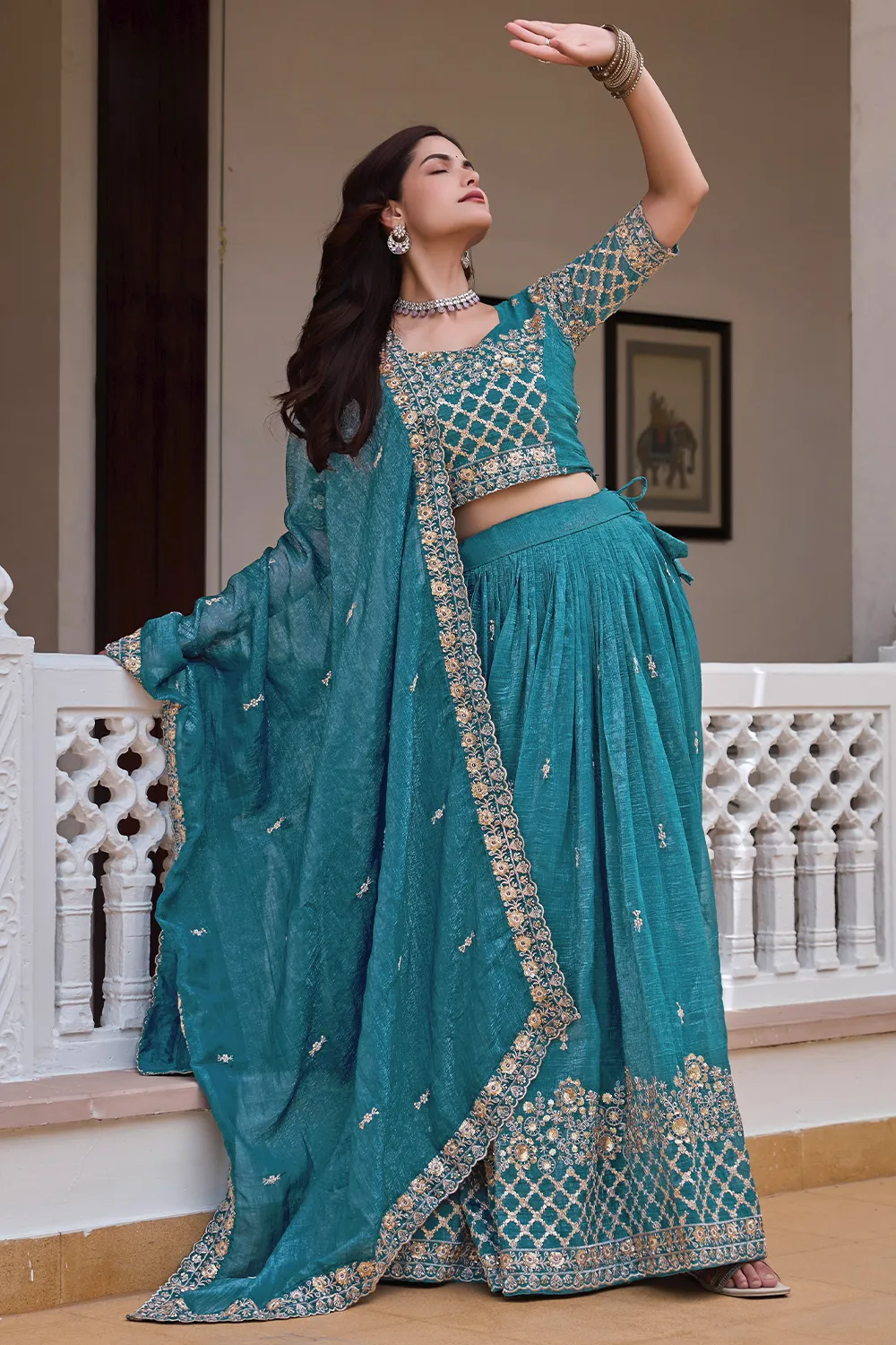 Teal blue crunchy silk lehenga styled with heavy embroidered dupatta