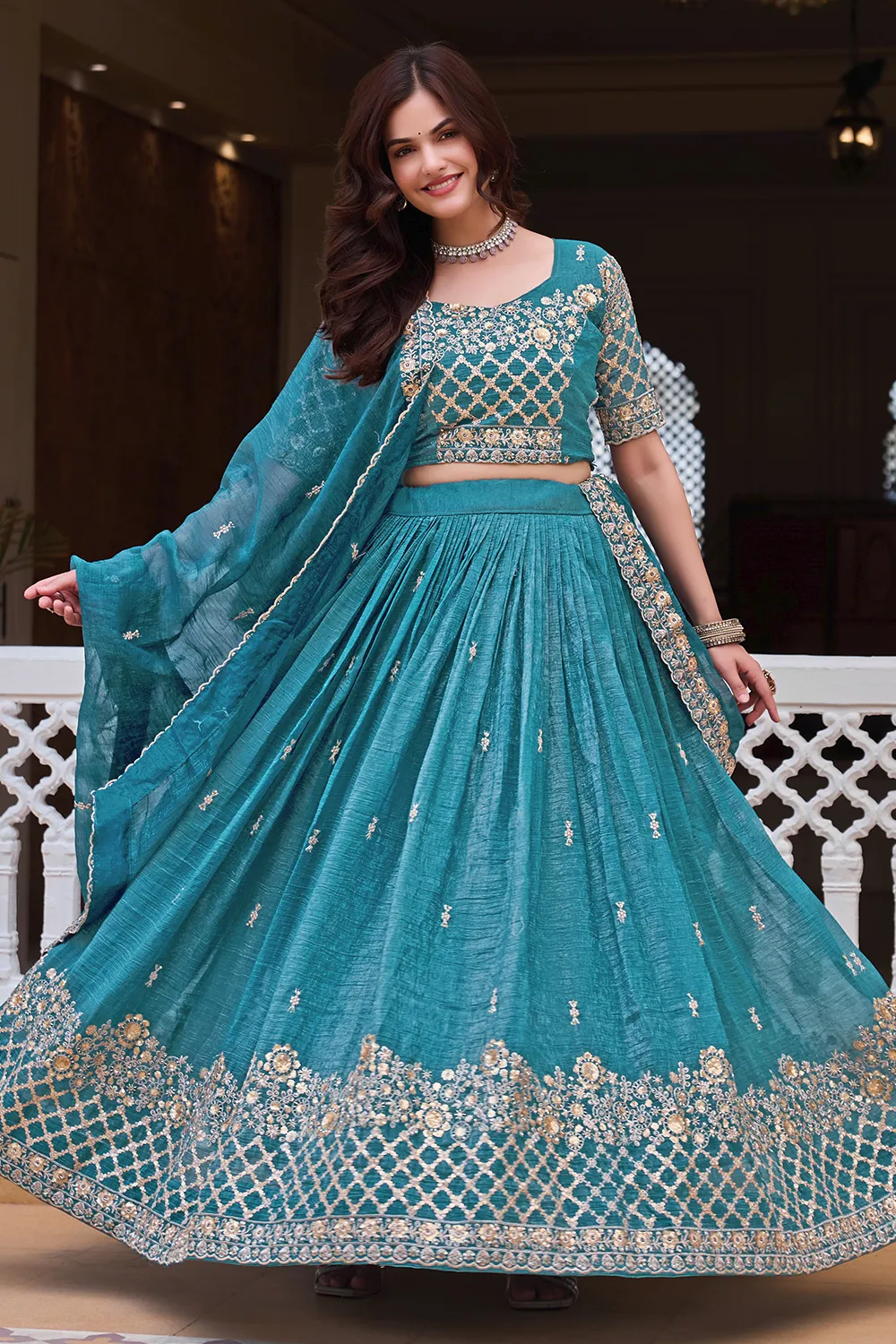 Embroidery and sequins work on teal blue crunchy silk lehenga skirt