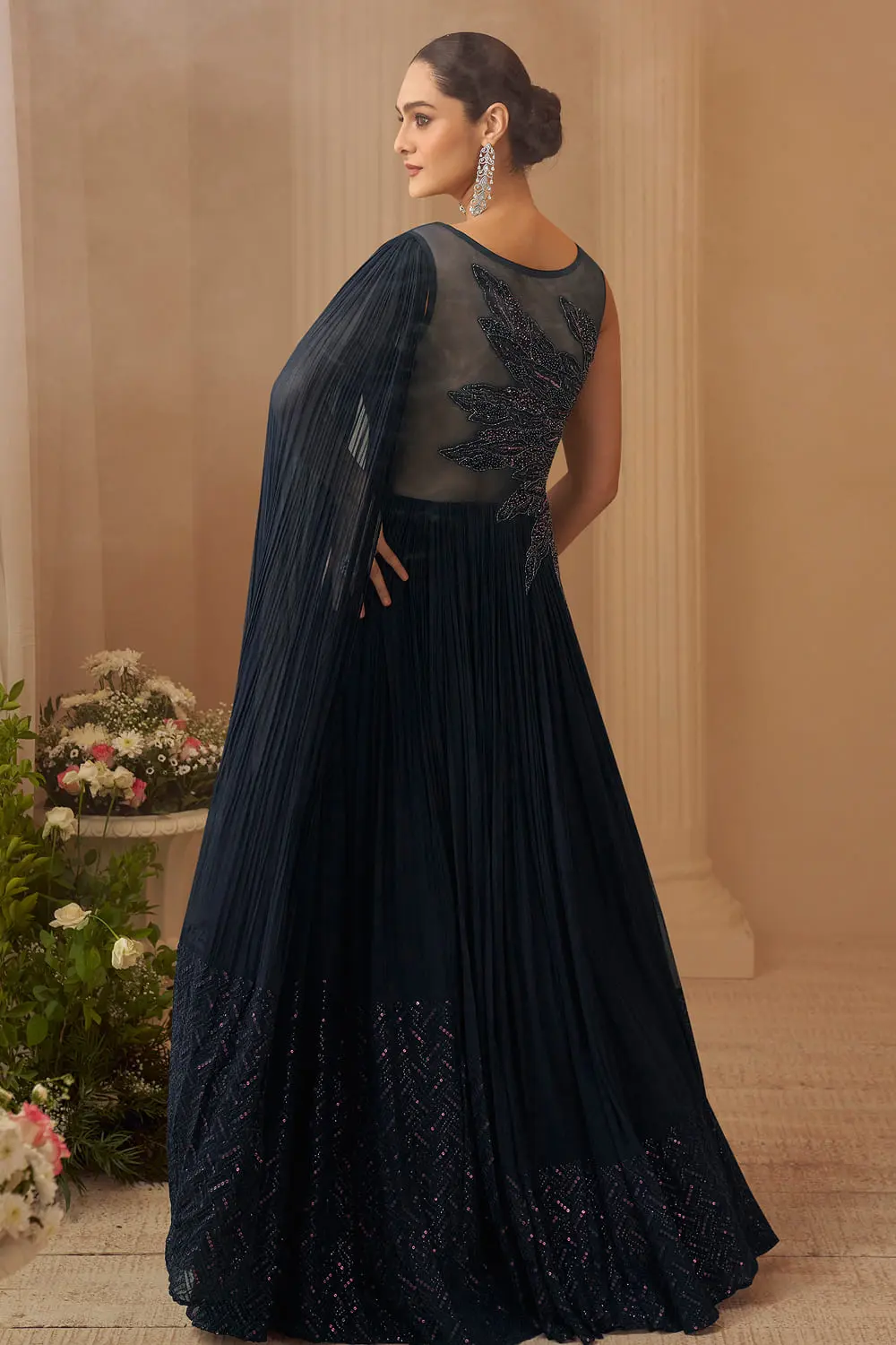 Back view of purple cape style wedding gown with front-and-back embroidery