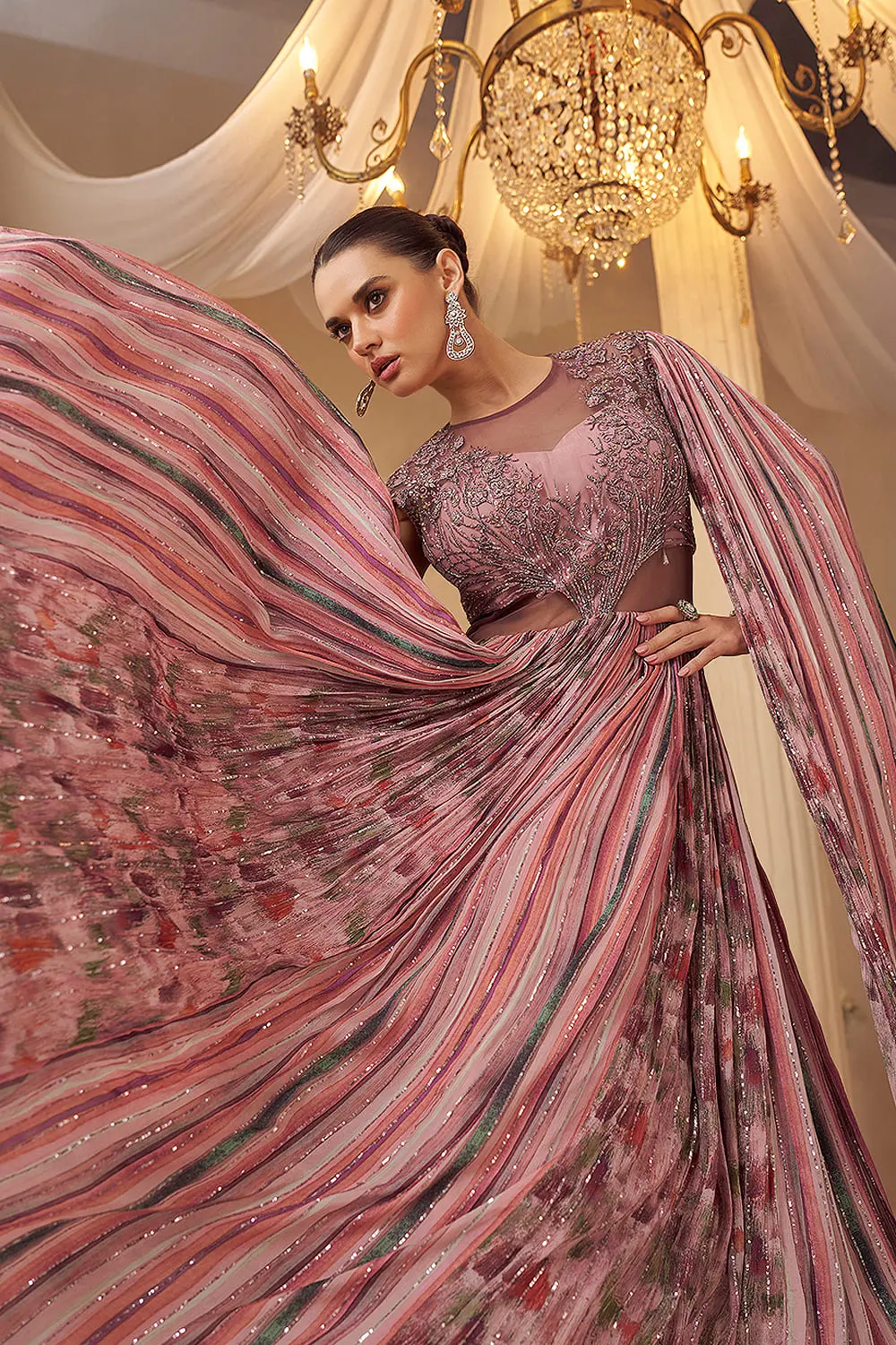 Close up of cape-style layer and embroidery on rose pink wedding gown