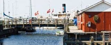 white and red boat on dock during daytime