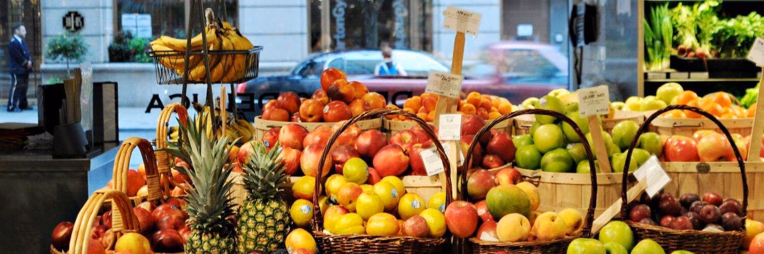 a bunch of baskets filled with different types of fruit