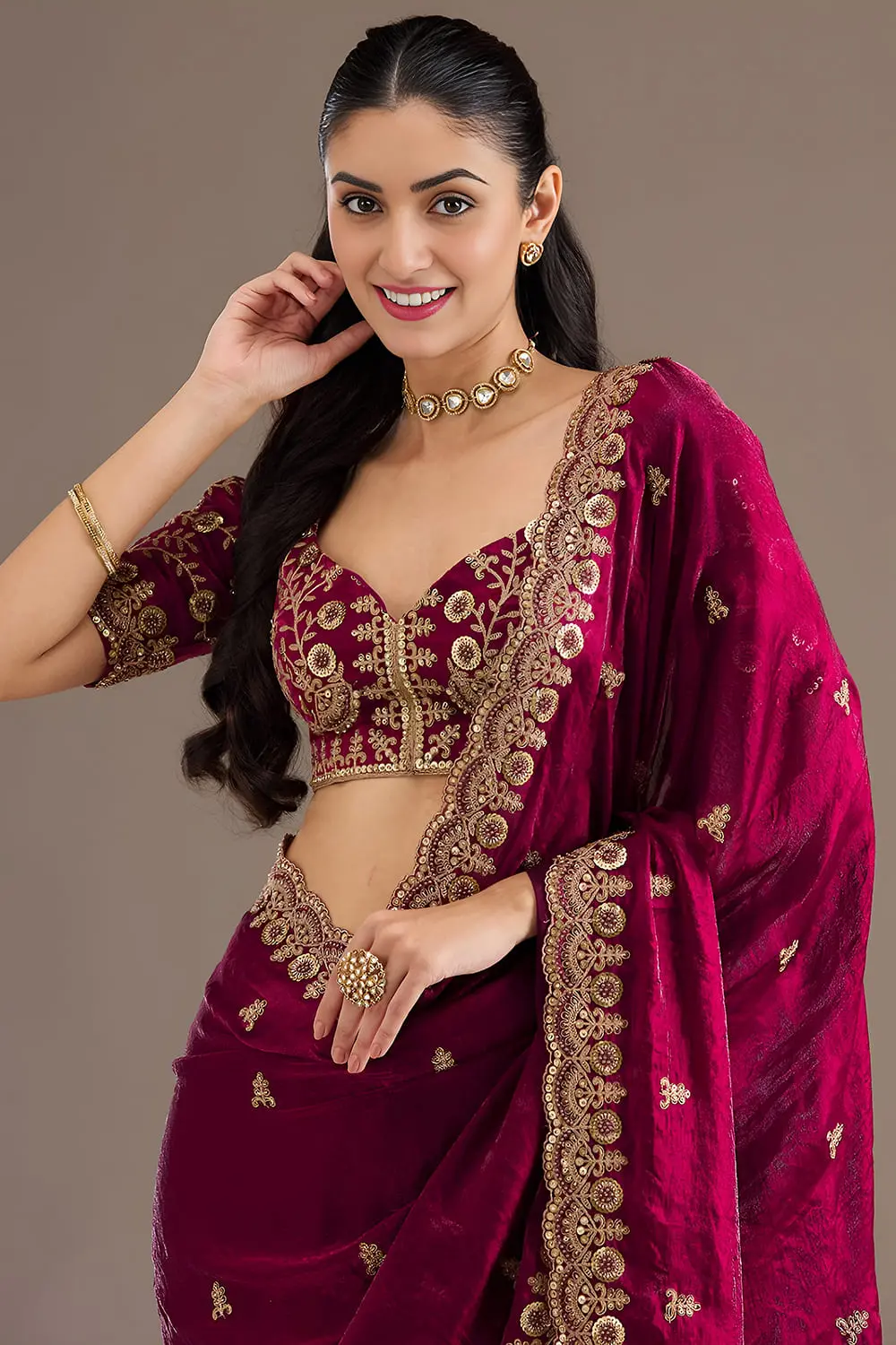 Close up of sequins, zari, diamond and pearl work on maroon saree