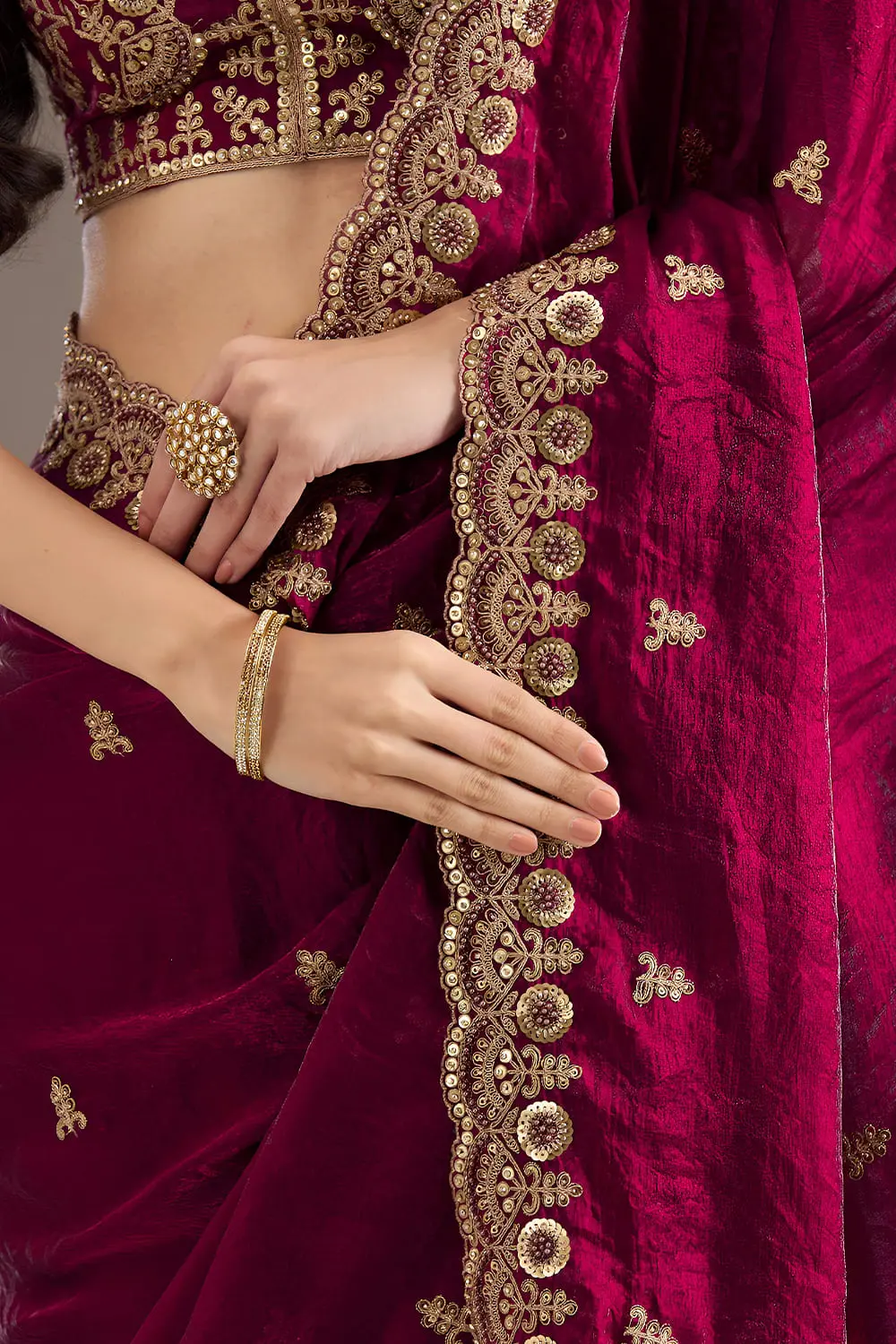 Embroidered border detail on maroon tissue silk saree