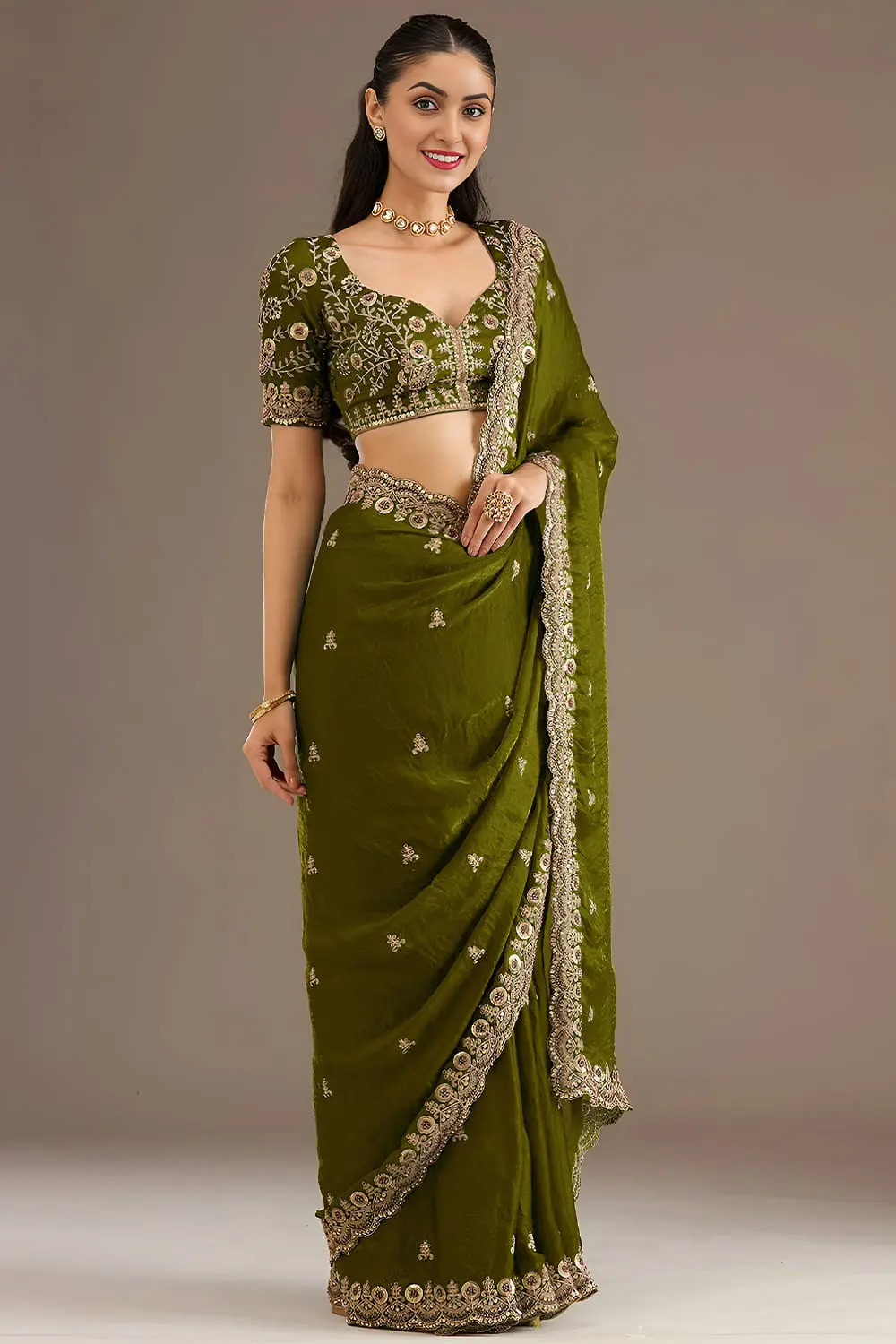 Warm olive green tissue silk saree draped full view