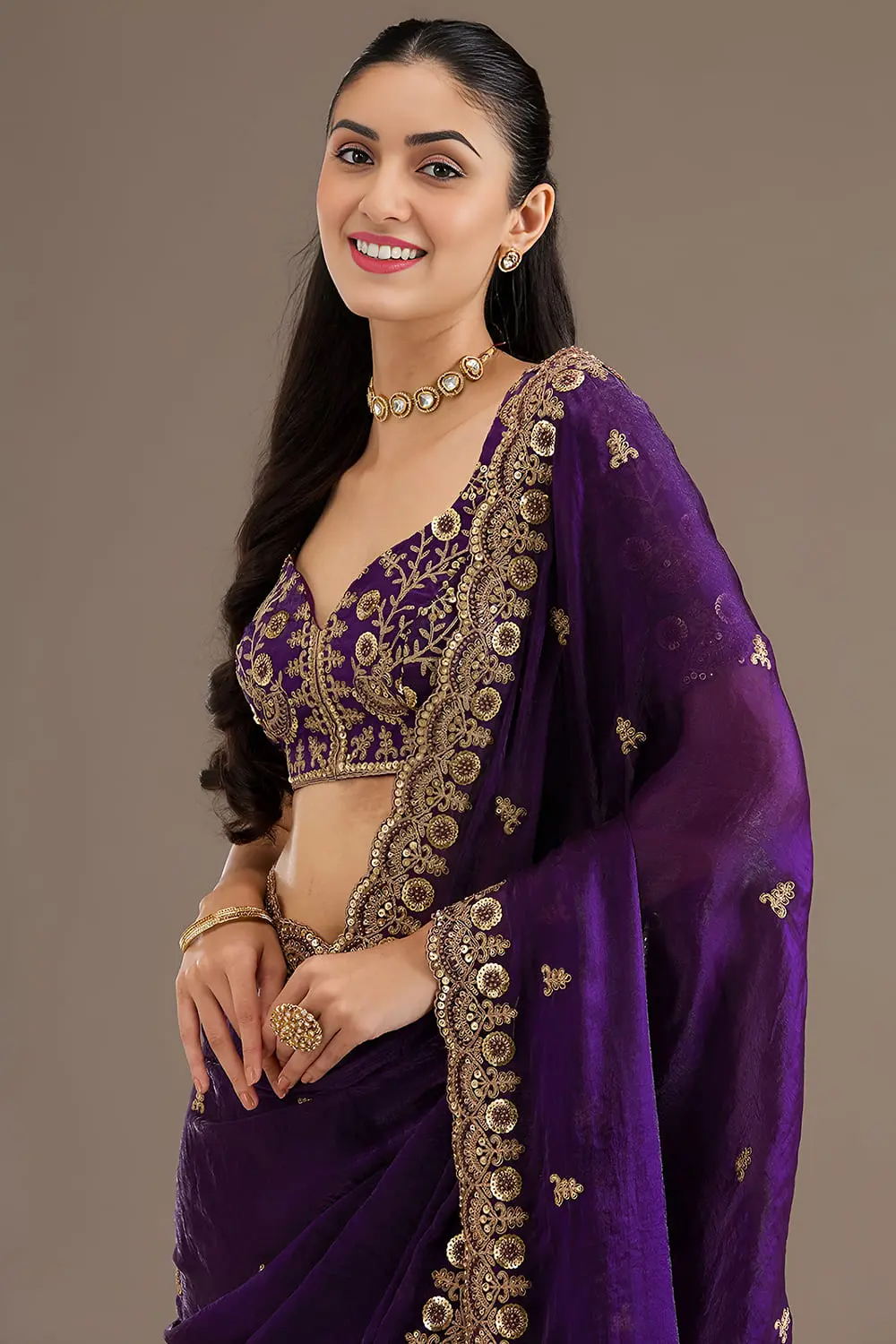 Close up of sequins, zari, diamond and pearl work on purple saree