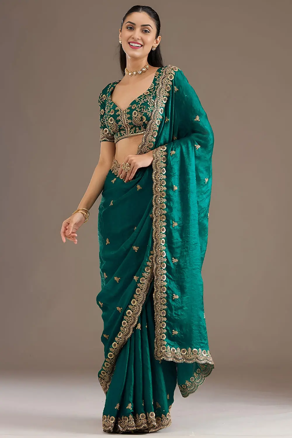 Side view of rama green tissue silk saree with sequins work