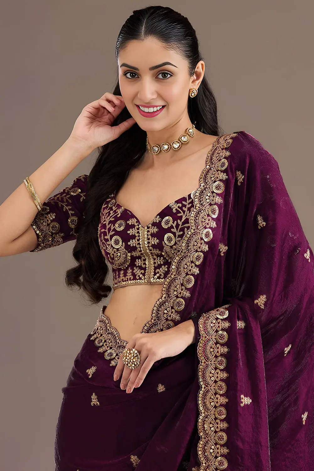 Close up of sequins, zari, diamond and pearl work on wine saree