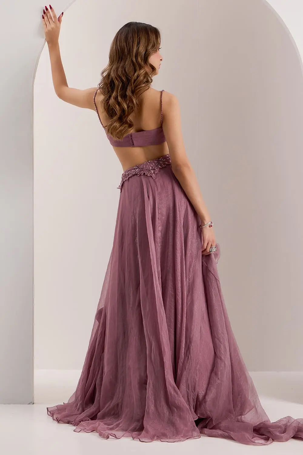 Back view of mauve corset lehenga showing bustier and organza skirt