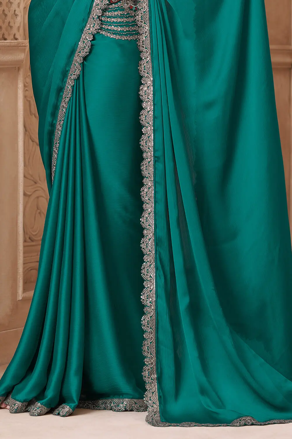Lustrous teal green satin silk saree pallu with embroidery