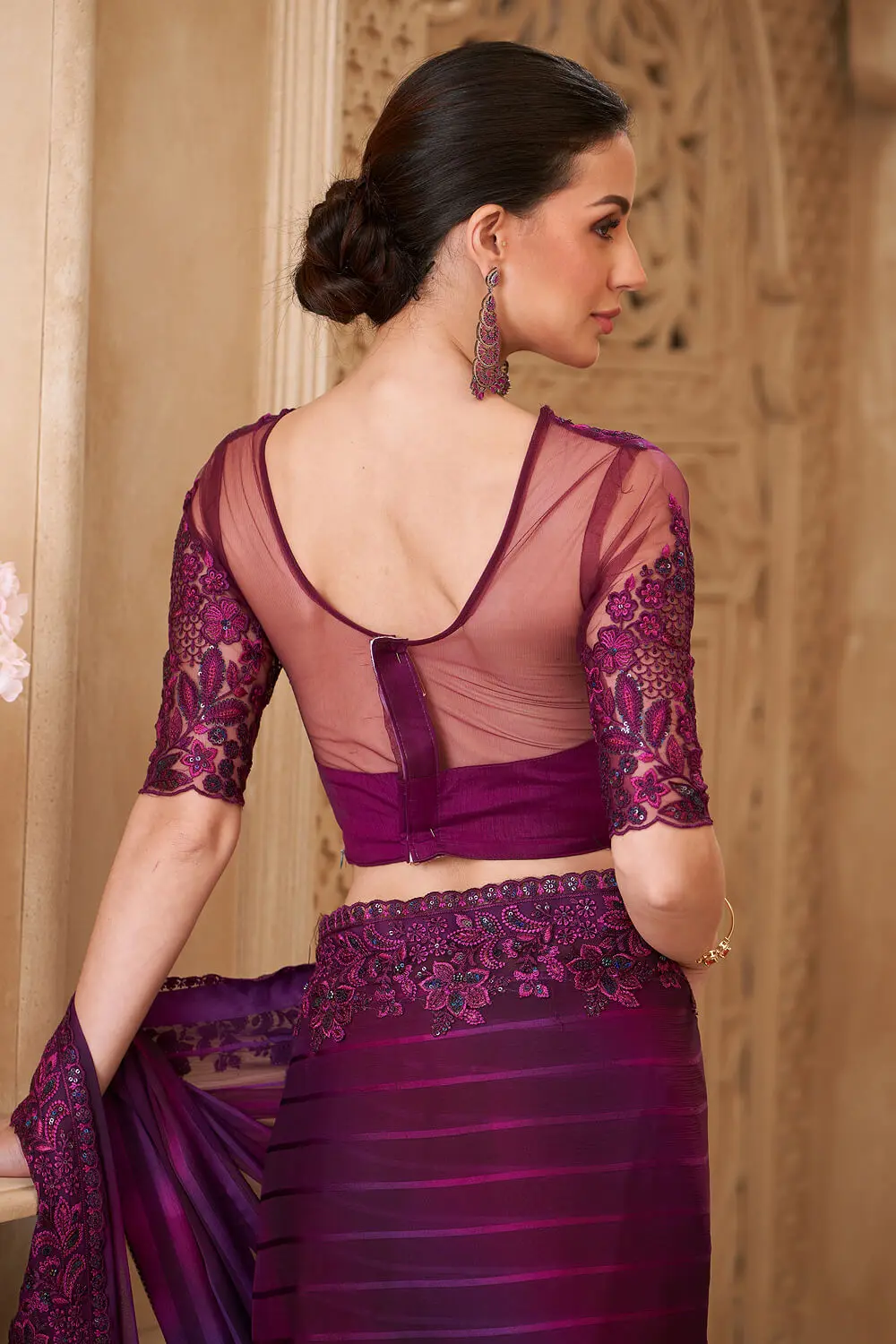 Embroidery work and tassel lace detail on deep purple georgette saree