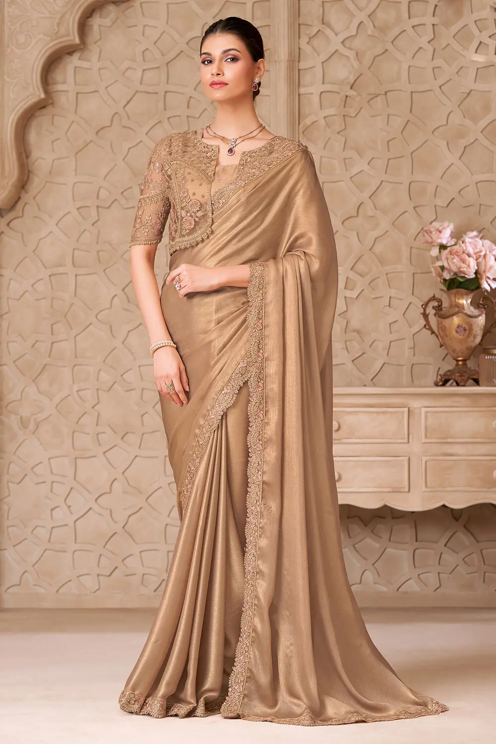 Close-up of intricate embroidery on gold saree jacket work blouse