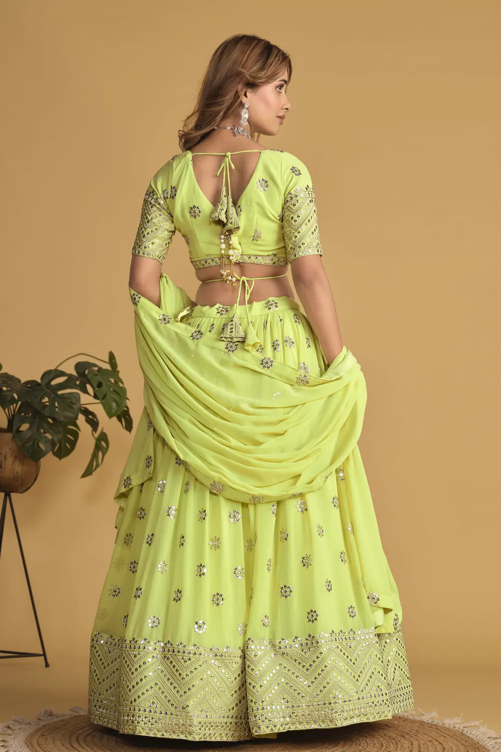Back view of neon georgette lehenga choli with sequins detailing