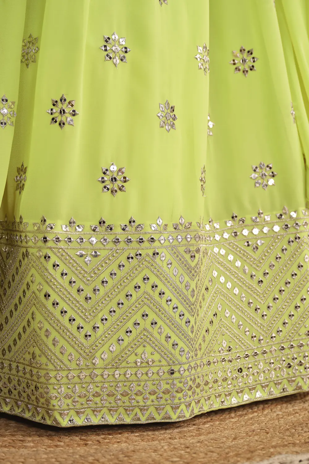 Close up of sequins and zari work on neon georgette lehenga