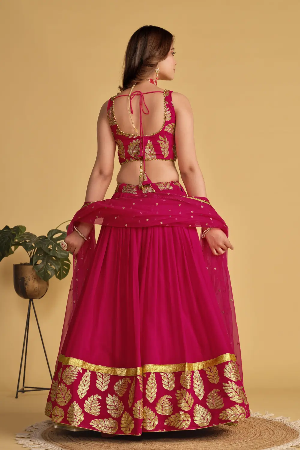 Back view of pink georgette lehenga choli with net dupatta