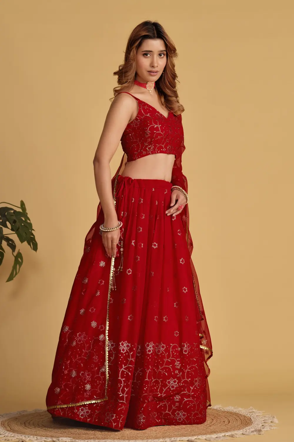 Red georgette lehenga styled with soft net dupatta and embroidered blouse