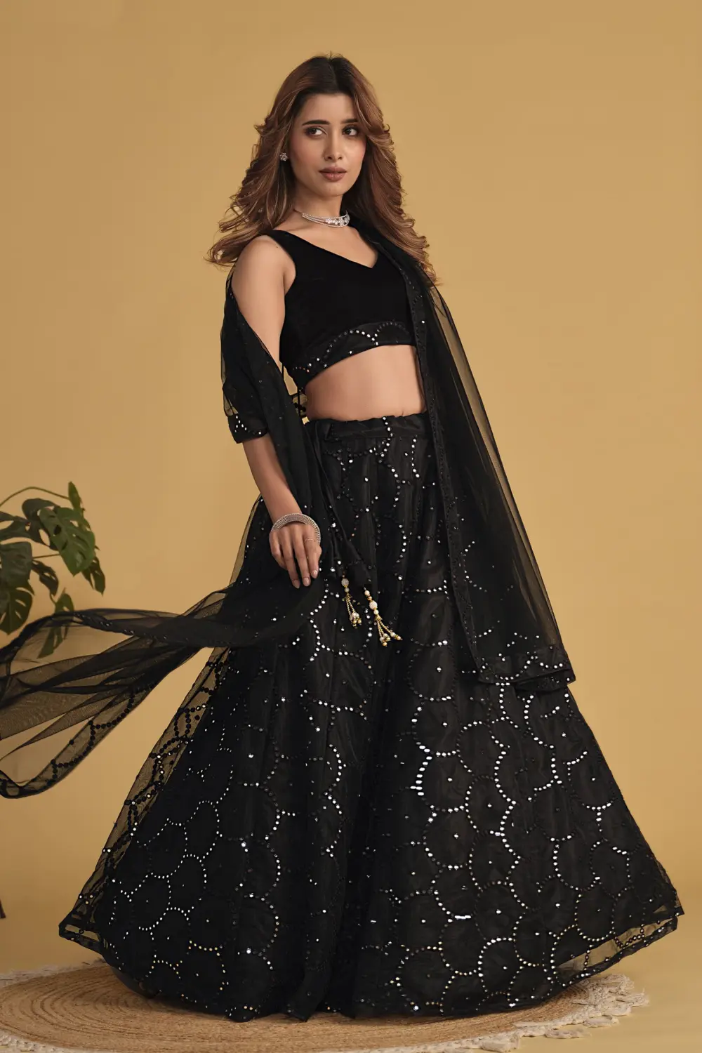 Black velvet blouse with georgette lehenga and soft net dupatta styled together
